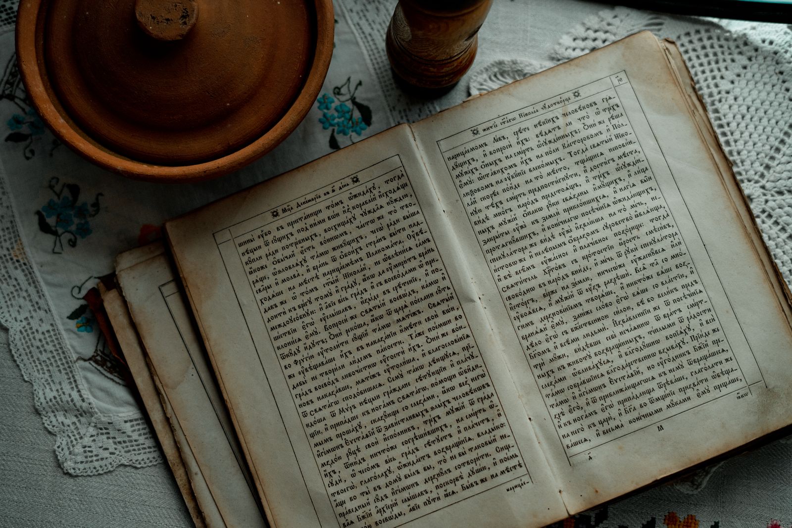 An old book open on a lace tablecloth