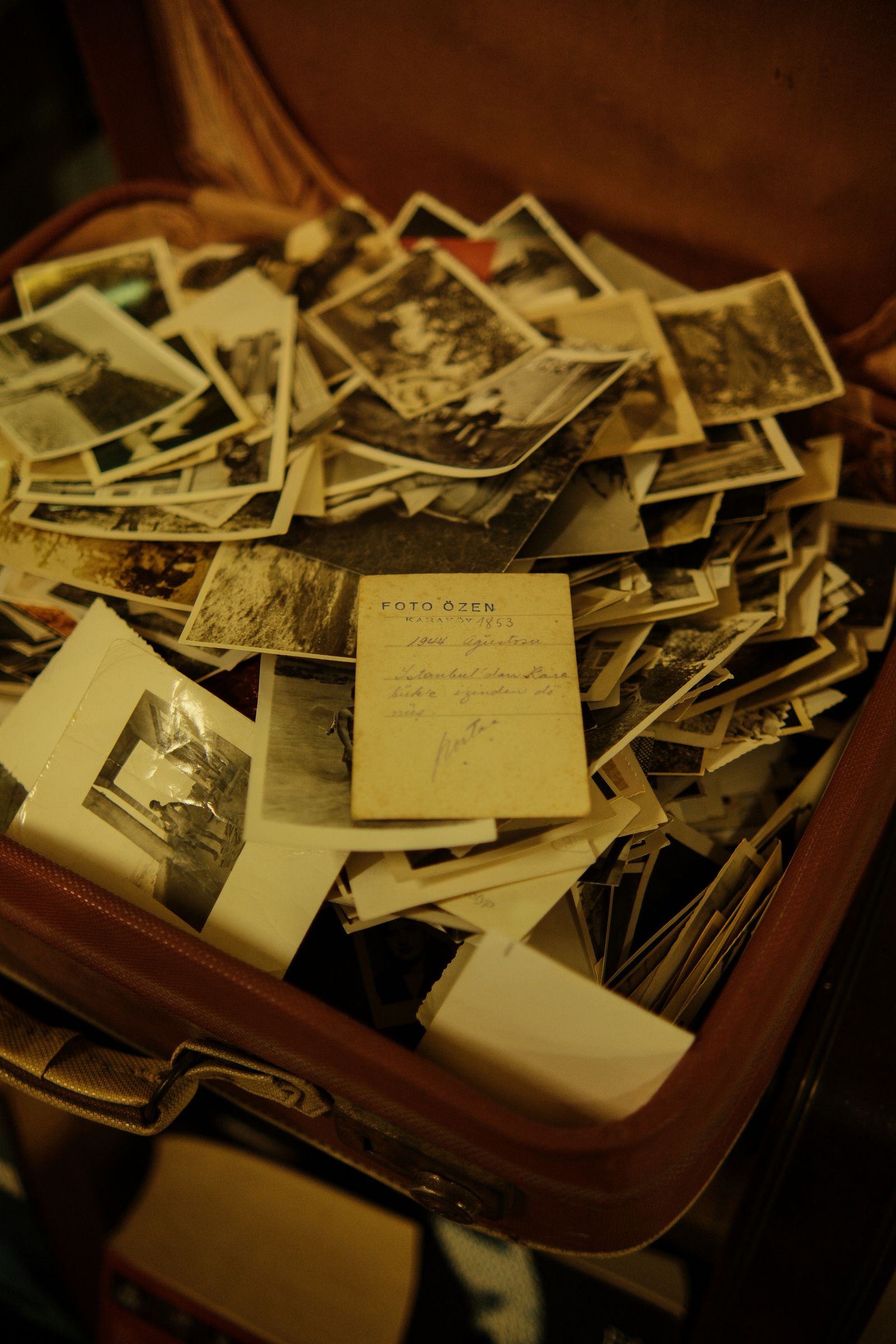 An old suitcase full of black-and-white photographs
