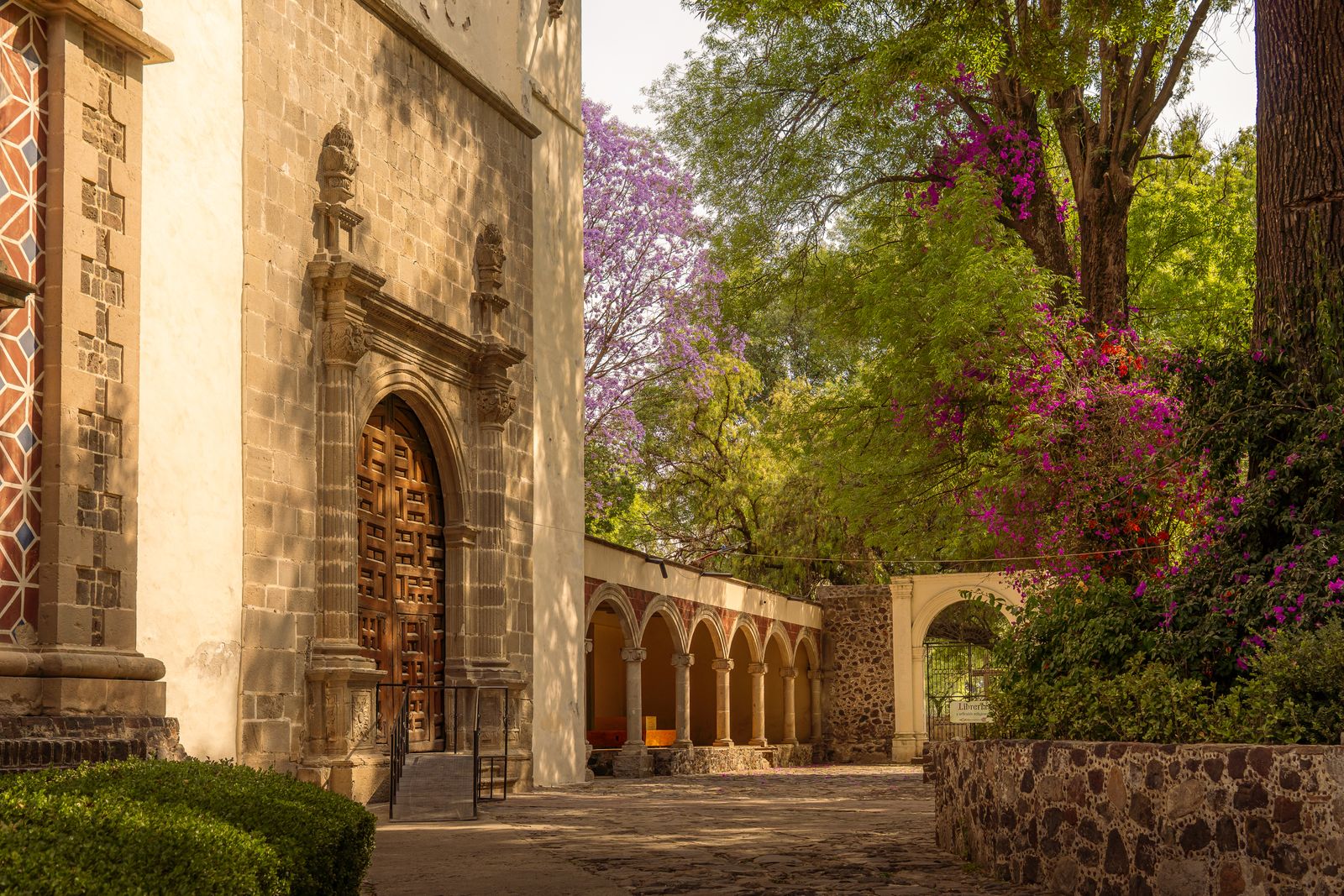 The stone facade of an old church in a Mexican town